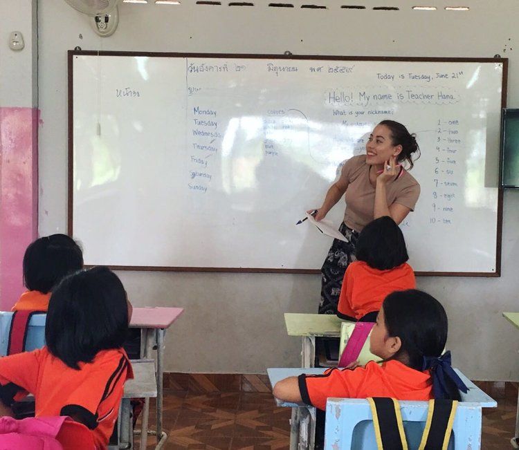 Transitioning Programs Volunteer teaching in front of a whiteboard